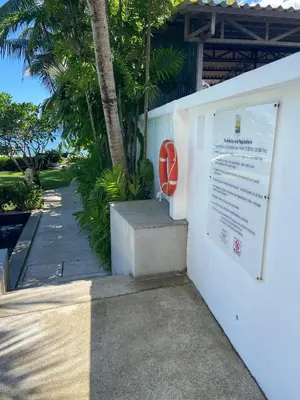 a sign on the side of a building with a wall at Luxuriously private seafront Bangtao beach in Surin Beach