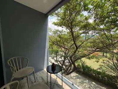 a room with a table and chairs and a large window at Citygate Kamala beach, luxury apartment, Phuket in Kamala Beach