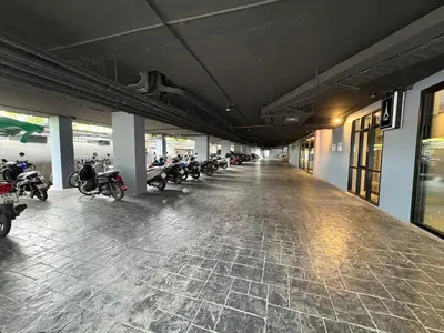 a row of motorcycles parked inside of a building at Citygate Kamala beach, luxury apartment, Phuket in Kamala Beach