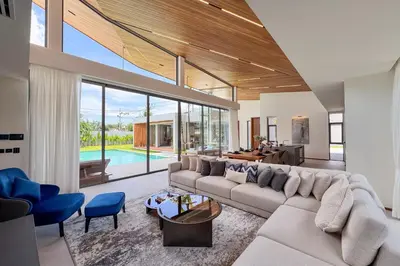 a living room with a large couch and blue chairs at New & Exclusive! Private 4BR Zenithy Luxe Pool Villa near Laguna in Bang Tao Beach