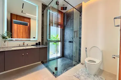 a bathroom with a shower and a toilet and a sink at New & Exclusive! Private 4BR Zenithy Luxe Pool Villa near Laguna in Bang Tao Beach