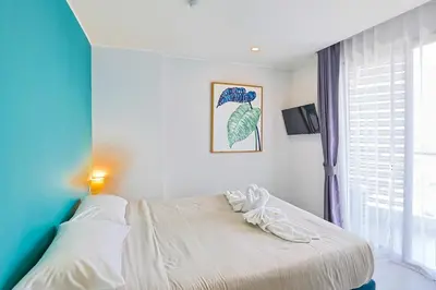 a bedroom with a bed and a window at Mountain View 1 Bed Apt T2-723 in Chalong