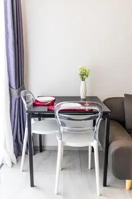 a table with two chairs and a table with a vase at Mountain View 1 Bed Apt T2-723 in Chalong