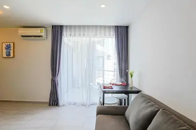 a living room with a couch and a table at Mountain View 1 Bed Apt T2-723 in Chalong