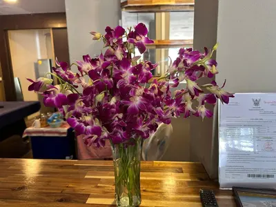 a vase of purple flowers sitting on a table at KT8 Hotel AoNang in Ban Khlong Haeng