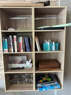 a wooden book shelf filled with books at KT8 Hotel AoNang in Ban Khlong Haeng