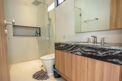 a bathroom with a sink and a toilet at Mouana Breeze Mai Khao VIP 4-bedroom Pool Villa 9913 in Mai Khao Beach