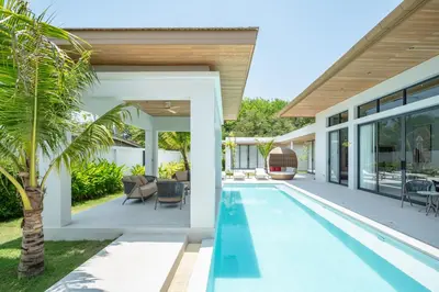 an indoor swimming pool in the backyard of a house at Mouana Breeze Mai Khao VIP 4-bedroom Pool Villa 9913 in Mai Khao Beach