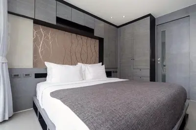 a bedroom with a large bed with white pillows at Citygate 2BR Suite CTG L402-3, Top Facilities, near FantaSea & Café Del Mar Beach Club in Kamala Beach