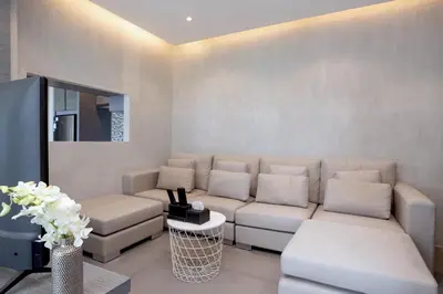 a living room with a couch and a tv at Tropics & Modern Stay - Kamala 2BR Suite CTG L502-3, Best Amenities & Beach Fun in Kamala Beach