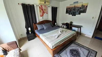 a bedroom with a bed with a wooden frame at Rawai Naiharn 3 bedroom house in Rawai Beach