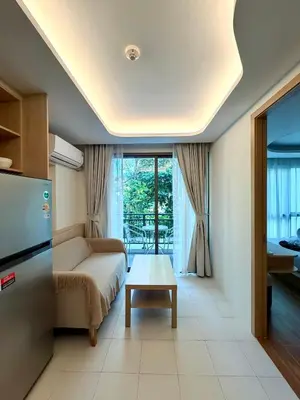 a living room with a couch and a table at 1-bd apartment on Kamala beach in Kamala Beach