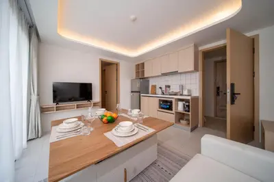 a kitchen with a table with plates on it at \u5168\u65b0\u4e8c\u5367\u516c\u5bd3\u73b0\u4ee3\u98ce\u683c in Phuket Town