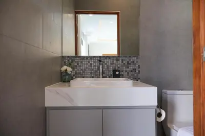 a bathroom with a sink and a mirror at Rawai Duplex Style Luxurious 4-BR Private Pool Villa in Rawai Beach