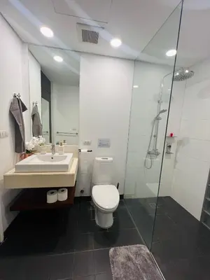 a bathroom with a toilet and a sink and a shower at Bangtao Beach Gardens in Surin Beach
