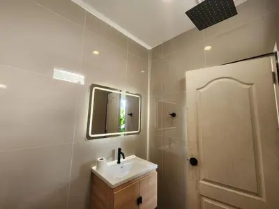 a white bathroom with a sink and a mirror at Wink City 2 Patong Center close to the Beach in Patong Beach