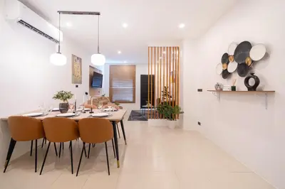a kitchen and dining room with a table and chairs at Wink Centre House 10 Patong Beach in Patong Beach