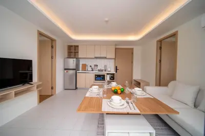 a living room with a table and a couch at now condo near beach 2bedroom in Kamala Beach