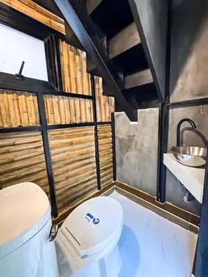a bathroom with a toilet and a sink at Water Lily Spa Bungalows by Rawai Beach in Rawai Beach