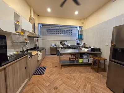 a large kitchen with a table in the middle at The Rock Patong Comfort Stay in Patong Beach