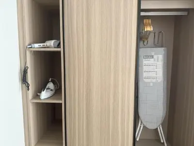 a closet with a refrigerator with a fan in it at THE BASE Rise Resort Style 1 & 2 Bedrooms in Ban Rangeng