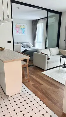 a living room with a couch and a table at Phuket apartment in Nai Yang Beach
