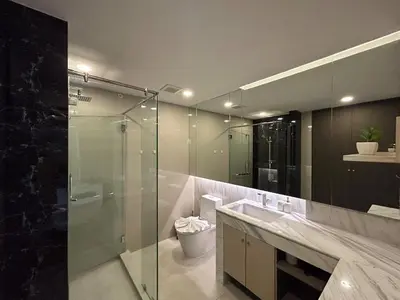 a bathroom with a glass shower and a sink at Seaview, 1 bd, Surin beach in Surin Beach