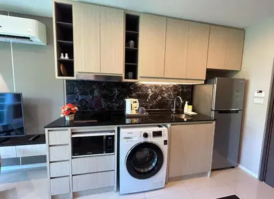 a kitchen with a washing machine and a refrigerator at Seaview, 1 bd, Surin beach in Surin Beach