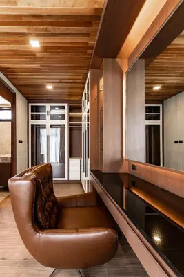 a brown leather couch in a room with wooden ceilings at Chariot by Villacarte in Layan Beach