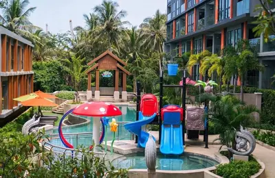 a pool with a water slide in a resort at Seaview, cozy apartment, Surin in Surin Beach