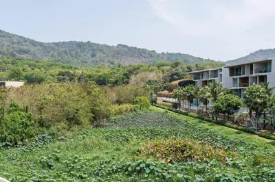 a garden in front of a building at The Lago by Villacarte in Rawai Beach