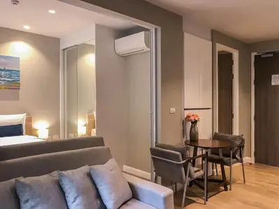 a living room with a couch and a table at Cozy apartment Banggtao beach in Bang Tao Beach