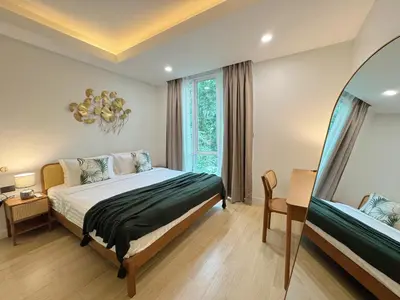 a bedroom with a bed and a large window at Tropical Living Kamala Hillside in Kamala Beach