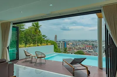 a balcony with two chairs and a swimming pool at Luxury Seaview Villa in Patong - Villa Yona in Patong Beach