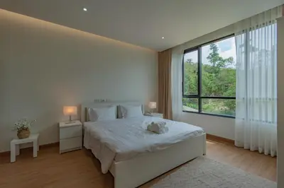 a bedroom with a bed with a large window at Luxury Seaview Villa in Patong - Villa Yona in Patong Beach