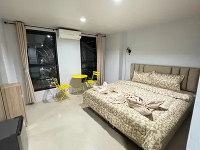 a bedroom with a bed and a large window at Miley Guesthouse in Phi Phi Don