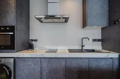 a kitchen with a sink and a stove at Pangolin villa Nai Thon Beach in Nai Thon Beach