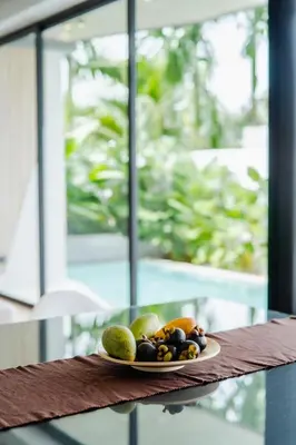 a plate of fruit sitting on a table at Pangolin villa Nai Thon Beach in Nai Thon Beach