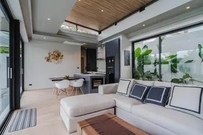 a living room with a white couch and a table at Pangolin villa Nai Thon Beach in Nai Thon Beach