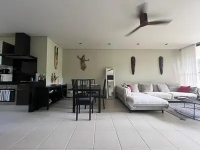 a living room with a couch and a ceiling fan at Secret Garden at Bangtao Beach in Surin Beach