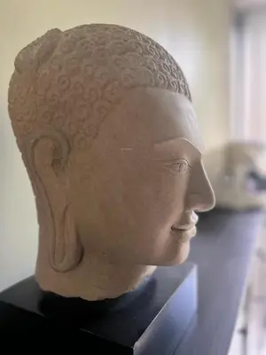 a statue of a head on display in a museum at Secret Garden at Bangtao Beach in Surin Beach
