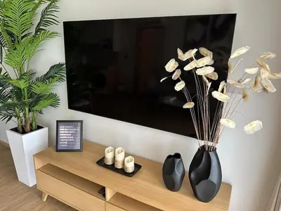 a living room with two black vases on a table at Laguna Beachside Residences 2bdr in Ban Thalat Choeng Thale