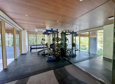 a gym with several exercise equipment in a building at Laguna Beachside Residences 2bdr in Ban Thalat Choeng Thale