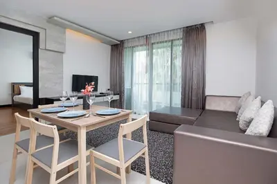 a living room with a table and a couch at Stylish Stay, Quiet Vibe - Apartment RGN B411 in Bangtao in Bang Tao Beach