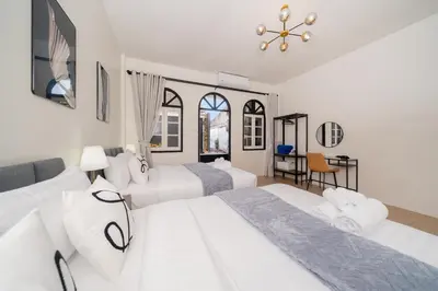 a bedroom with two beds and a table at Beachside Patong 50m or less min walk in Patong Beach