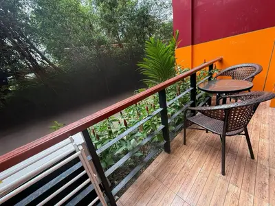 a patio with a table and chairs on a deck at апартаменты NBC Nai Harn in Rawai Beach