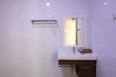 a white bathroom with a sink and a mirror at Paradise Resort Phi Phi in Phi Phi Don