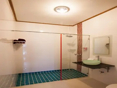 a bathroom with a glass shower with a sink at Paradise Resort Phi Phi in Phi Phi Don