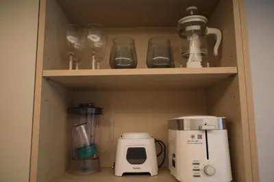 a cupboard with various kitchen items in it at Apartment by the sea Kamala Beach A502 in Kamala Beach