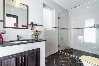 a bathroom with a shower and a sink and a toilet at Luxurious & Quiet Pool Villa Orchid in Nai Yang Beach